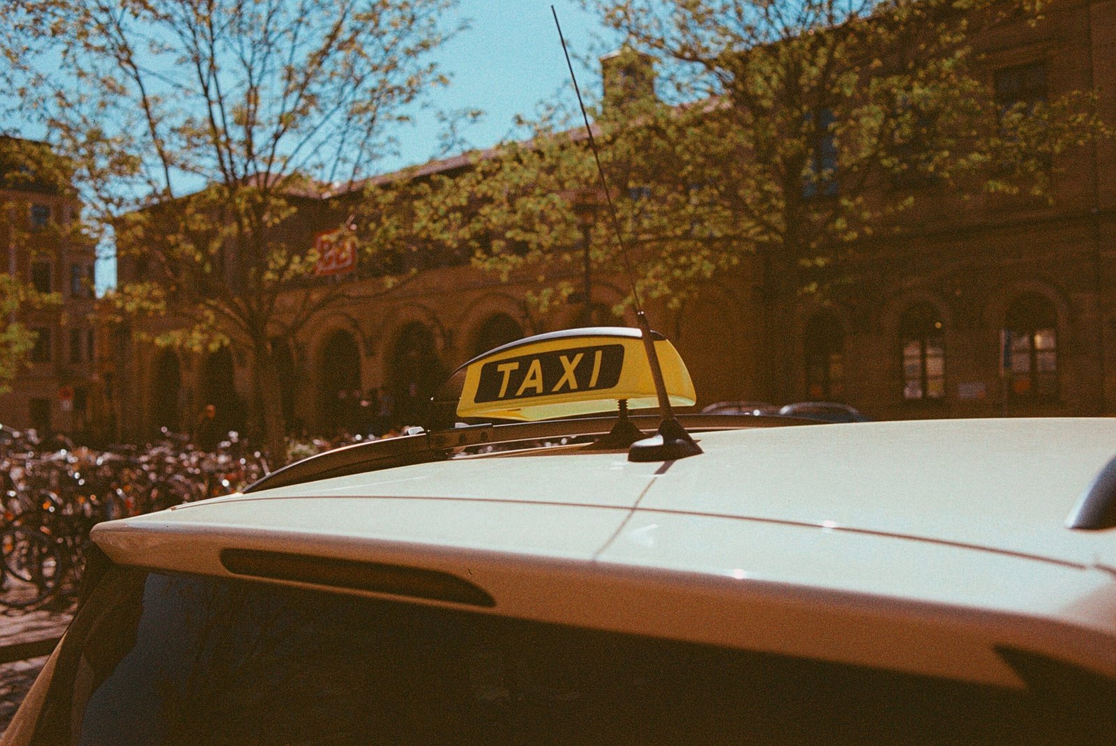 yellow taxi cab on road during daytime